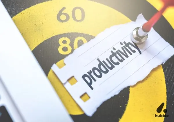 A dart hitting a target with the word "productivity," symbolizing the impact of employee well-being programs on workplace efficiency