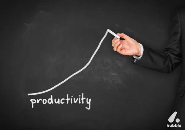Hand drawing an upward productivity graph on a blackboard, representing the impact of SPIFs and sales contests on performance.
