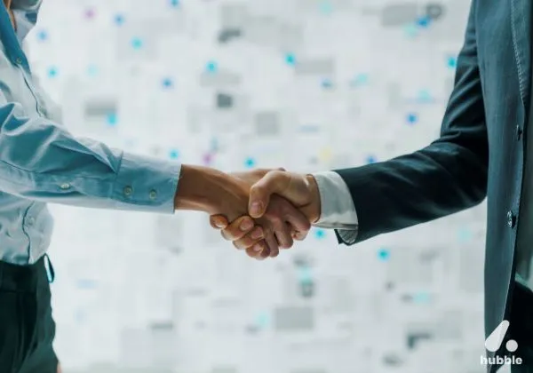Two business professionals shaking hands, symbolizing successful engagement and retention strategies for channel partners.