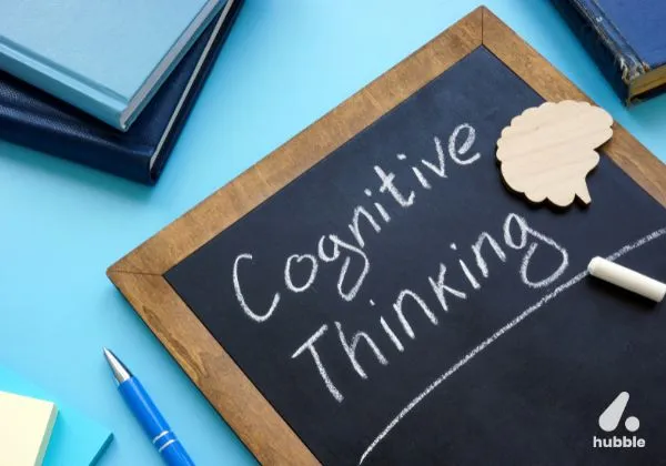A chalkboard with "Cognitive Thinking" written on it, representing cognitive biases in marketing decision-making