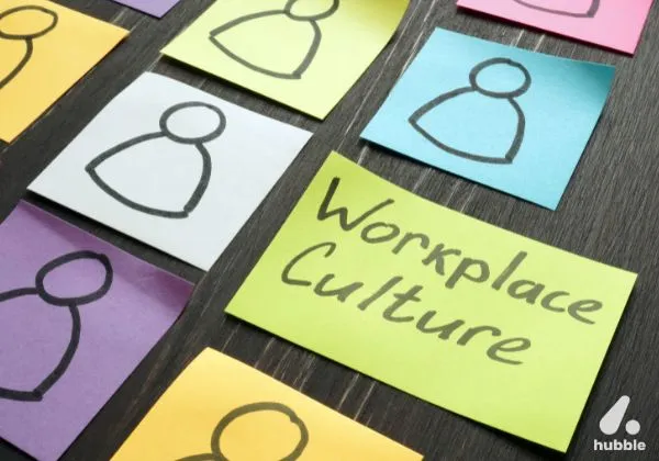 Sticky notes with drawn human icons representing employees, with a prominent yellow note labeled "Workplace Culture," symbolising efforts to build an inclusive and supportive work environment.